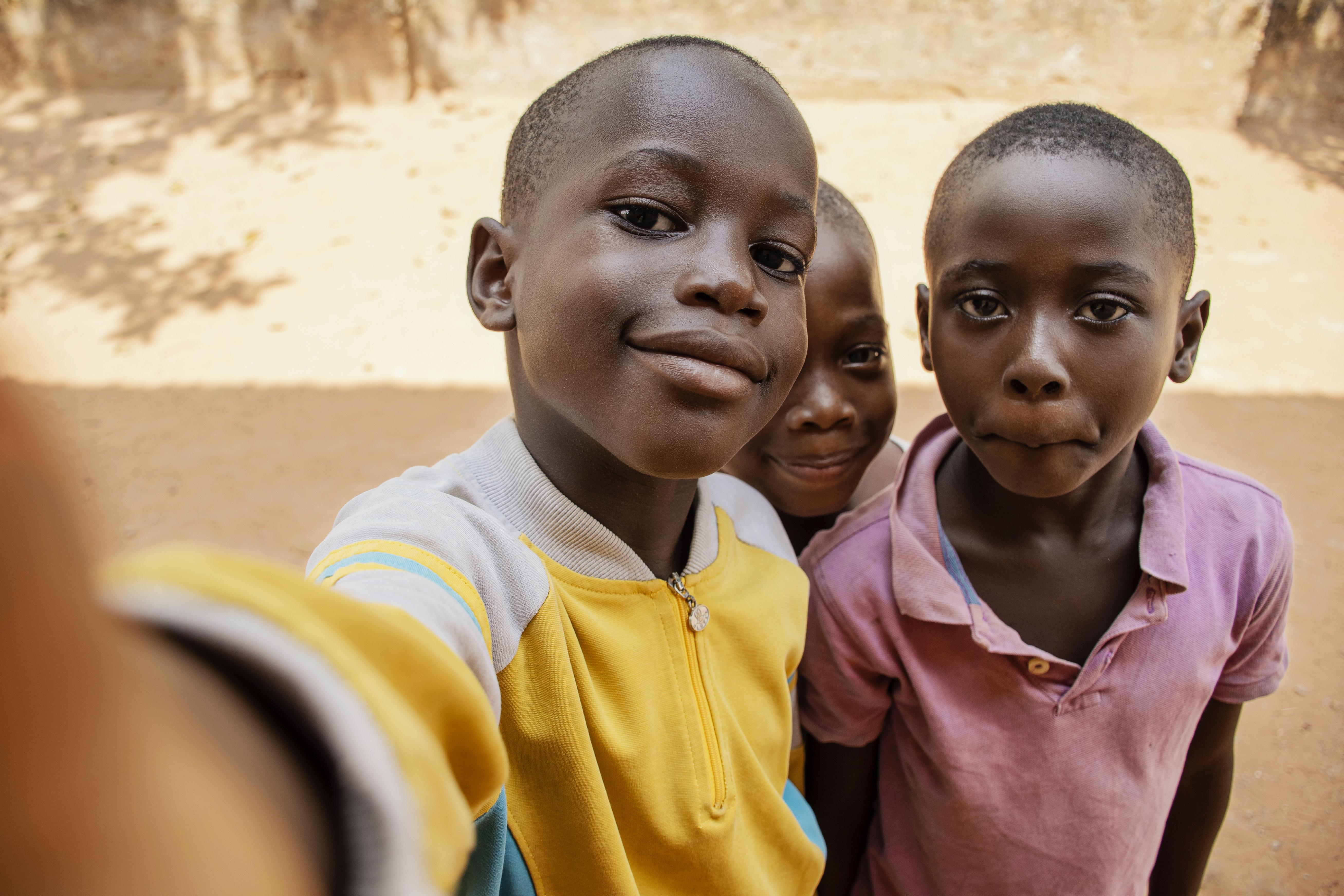 Children taking a joyful selfie together.